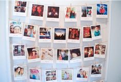 many pictures are hung on a clothes line