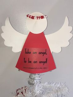 an angel decoration on top of a christmas tree