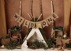 there is a teepee tent and decorations on the table