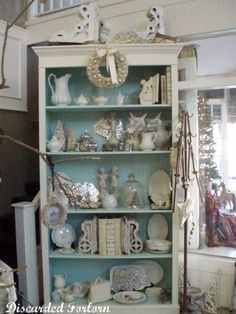 an old china cabinet is decorated with christmas decorations and other items for the holiday season