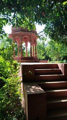 steps leading up to a gazebo surrounded by trees