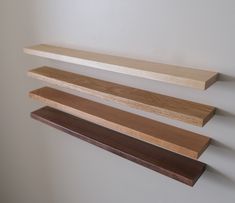 three wooden shelves mounted to the wall