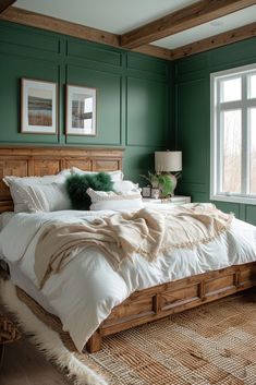 a bedroom with green walls and white bedding