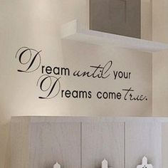 there is a wall decal that says dream until your dreams come true