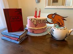 a table topped with two cakes and books