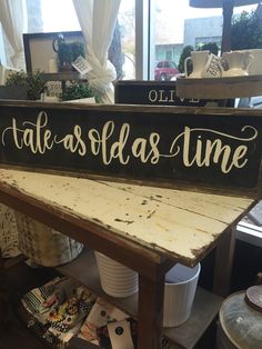 a wooden sign that says, tate asflas time on the side of a table