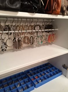 a white shelf filled with lots of jewelry