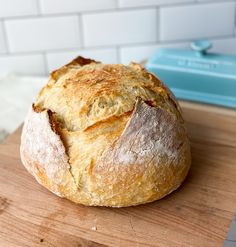 a loaf of bread sitting on top of a wooden cutting board