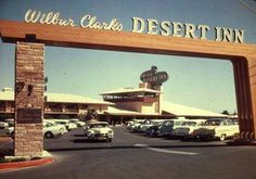 cars are parked in front of the entrance to a desert inn with a sign that says william clark's desert inn