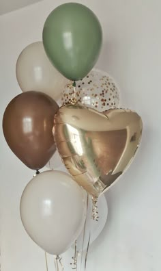 a bunch of balloons that are in the shape of heart shaped balloons with gold and white confetti on them