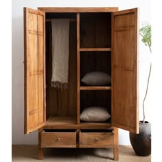 an armoire with two drawers and one door open to show the linens inside