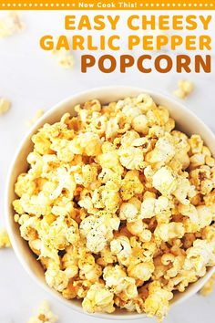 an easy cheesy garlic popcorn recipe in a white bowl with the title above it