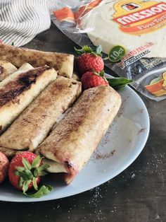 a plate full of food with strawberries on the side