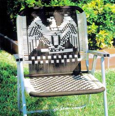 a black and white chair sitting in the grass