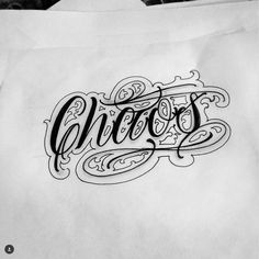 the word chaos written in cursive writing on paper