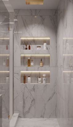 a bathroom with white marble walls and shelves