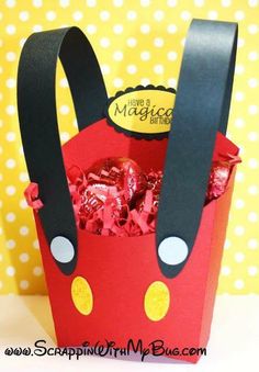 a red basket filled with chocolates on top of a table