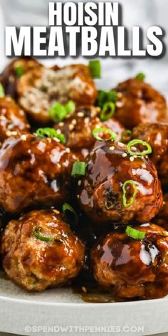 the meatballs are covered in sauce and garnished with green onions