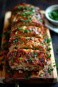 sliced meatloaf on a cutting board with parsley sprinkled around it