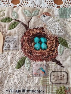 a close up of a bird nest with eggs in it on a lace doily