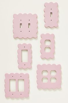 pink scalloped switchplates and plates on a white surface with the number eight