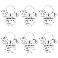 six personalized keychais with hearts and names on the front, one for each child