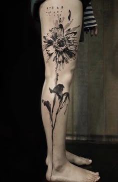 a woman's leg with a sunflower tattoo on it