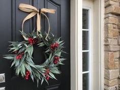 a wreath is hanging on the front door