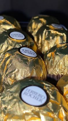 gold foil wrapped chocolates are stacked on top of each other