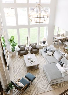 a living room filled with furniture and large windows