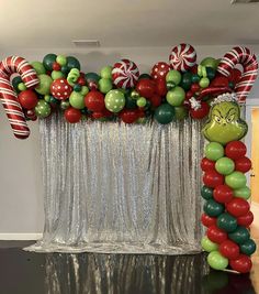 the grinch balloon arch is decorated with candy canes and lollipops