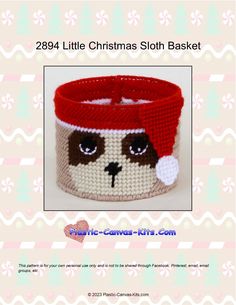 a crocheted christmas sloth basket with a red hat on it