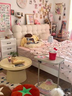 a bed room with a neatly made bed and lots of decorations on the wall above it