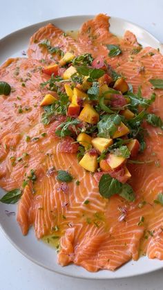 a white plate topped with salmon and vegetables