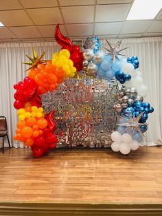 an arch made out of balloons and streamers