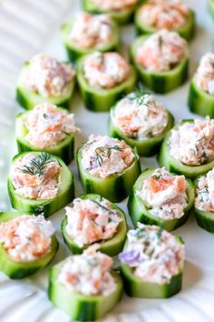 cucumbers filled with crab salad on a white plate