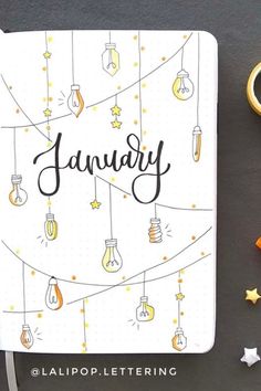 a notebook with the word january written on it next to some scissors and other items