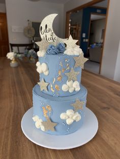 a blue cake with stars and moon decorations