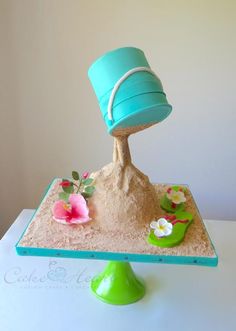 there is a cake made to look like a tree on top of the sand and water