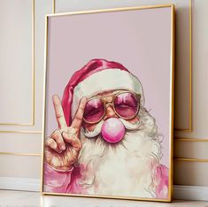 a painting of santa claus wearing sunglasses and giving the peace sign