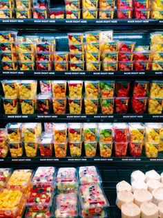 many plastic containers filled with different types of fruit