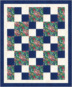 a blue and white quilt that has flowers on it, in the middle of a checkerboard pattern