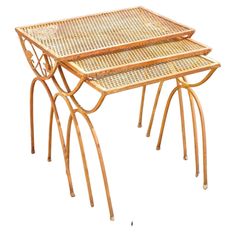 two wicker tables with metal legs on each side, one sitting on top of the other