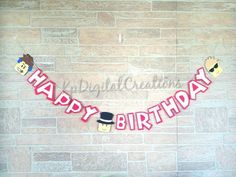 a happy birthday banner hanging on a brick wall