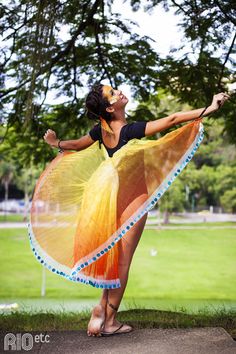 a woman in a yellow and blue dress is dancing