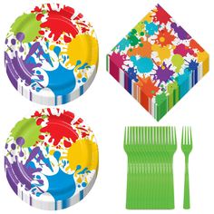 three plates with different designs on them next to a green fork and napkins that have colorful paint splatters on them