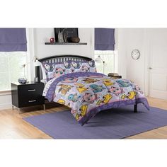 a bed with winnie the pooh comforter and purple bedspread in a bedroom