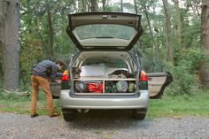 a man loading his car with luggage in the trunk