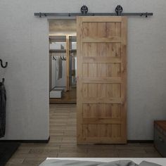 an open wooden door in a bedroom with white walls and wood flooring on the side