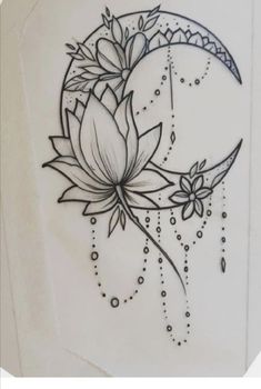 a black and white drawing of a crescent moon with flowers on it's side